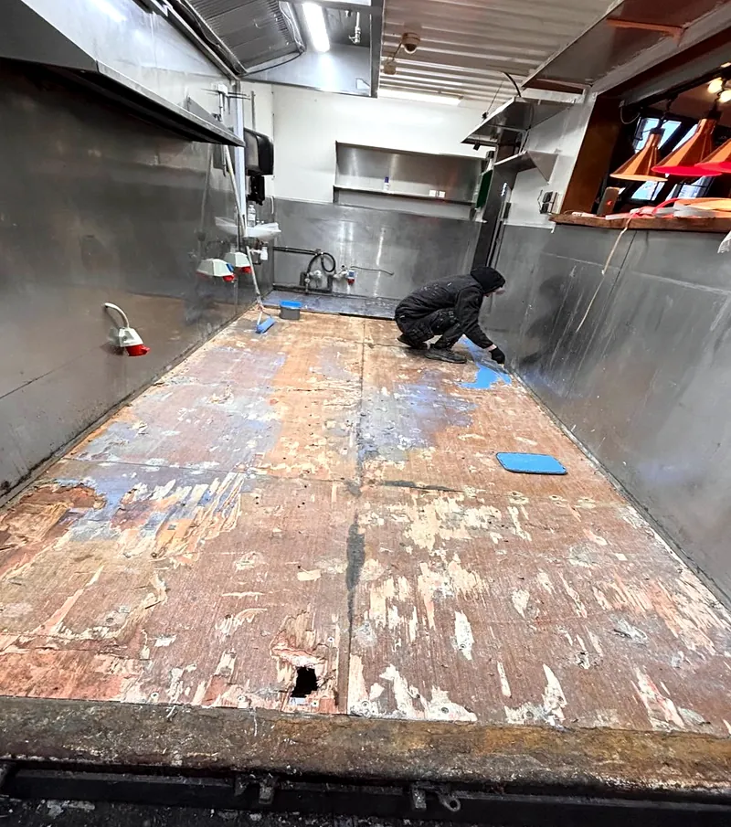 Før: Køkkengulv i foodtruck med slidt og ujævnt undergulv